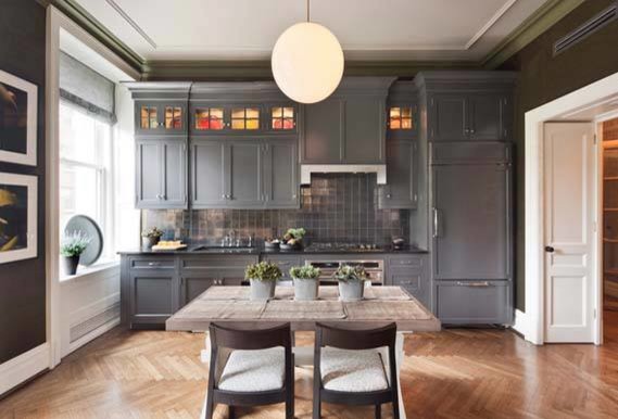 Example of a mid-sized transitional single-wall medium tone wood floor eat-in kitchen design in New York with an undermount sink, beaded inset cabinets, gray cabinets, marble countertops, black backsplash, metal backsplash, paneled appliances and no island
