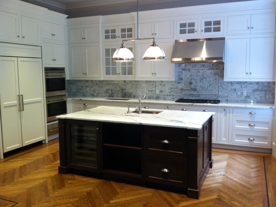 Inspiration for a large transitional l-shaped medium tone wood floor eat-in kitchen remodel in New York with an undermount sink, beaded inset cabinets, light wood cabinets, marble countertops, white backsplash, subway tile backsplash, stainless steel appliances and an island