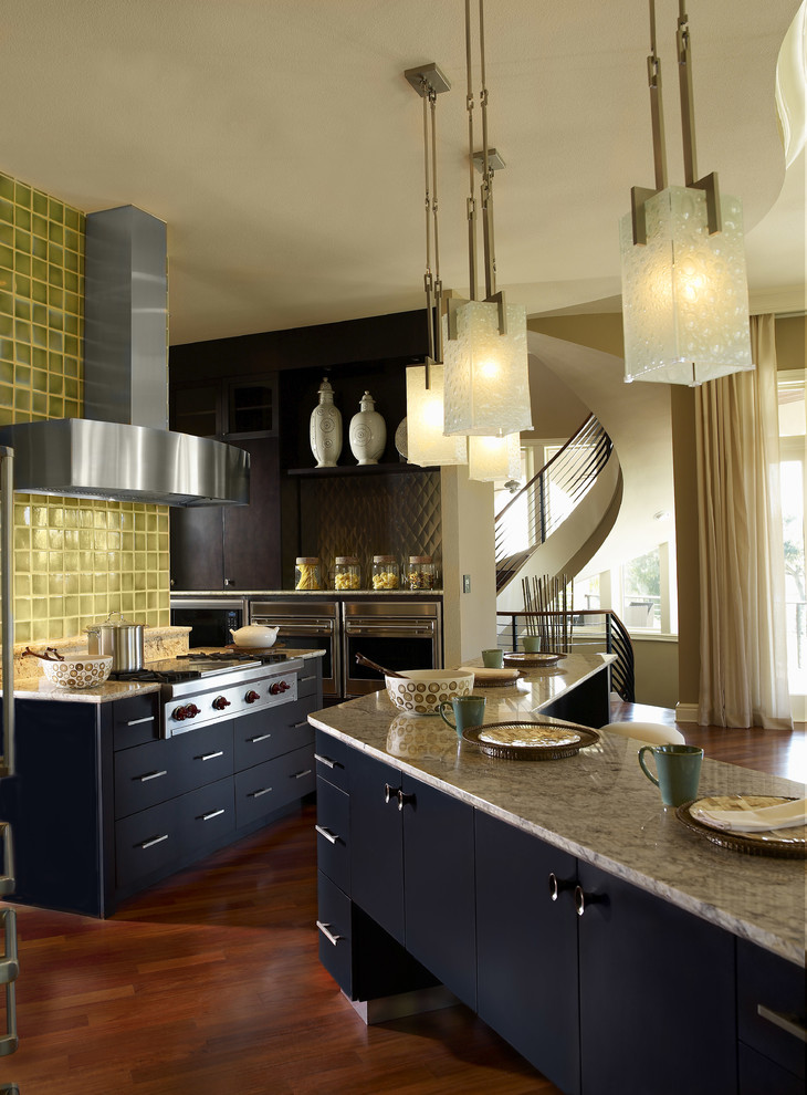 Inspiration for a large contemporary l-shaped open plan kitchen in Tampa with stainless steel appliances, flat-panel cabinets, black cabinets, green splashback, granite worktops, ceramic splashback, dark hardwood flooring, an island and brown floors.