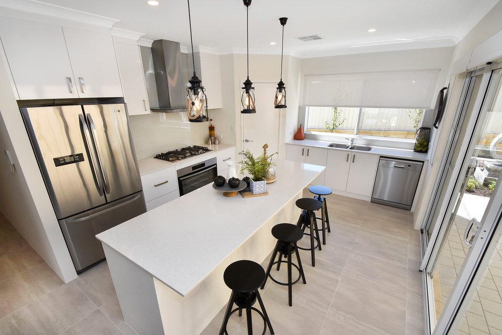 Inspiration for a medium sized modern galley open plan kitchen in Perth with a double-bowl sink, beaded cabinets, white cabinets, composite countertops, grey splashback, glass tiled splashback, stainless steel appliances, ceramic flooring, an island and beige floors.