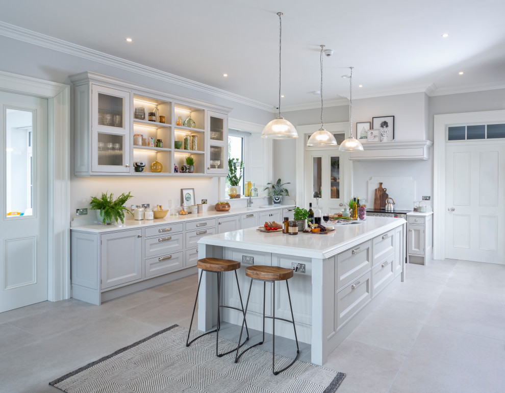 Design ideas for a traditional u-shaped kitchen/diner in Other with a submerged sink, recessed-panel cabinets, grey cabinets, white splashback, integrated appliances, an island, beige floors and white worktops.