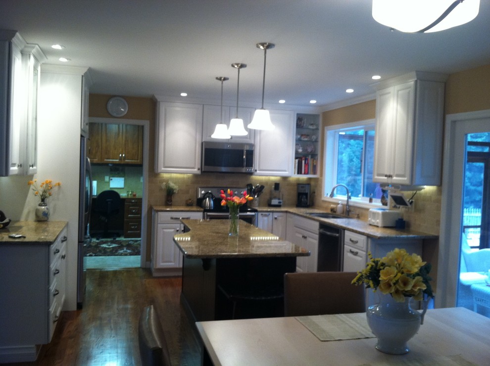 Eat-in kitchen - mid-sized transitional medium tone wood floor eat-in kitchen idea in Boston with an undermount sink, raised-panel cabinets, white cabinets, granite countertops, beige backsplash, ceramic backsplash, stainless steel appliances and an island