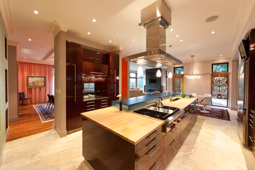 Design ideas for a contemporary kitchen/diner in Edmonton with stainless steel appliances and wood worktops.