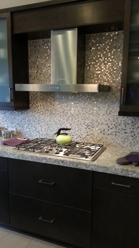 Example of a trendy u-shaped eat-in kitchen design in Jacksonville with an undermount sink, flat-panel cabinets, dark wood cabinets, quartz countertops, gray backsplash and stainless steel appliances