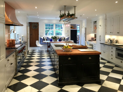 Inspiration for a modern marble floor eat-in kitchen remodel in New York with white cabinets and an island