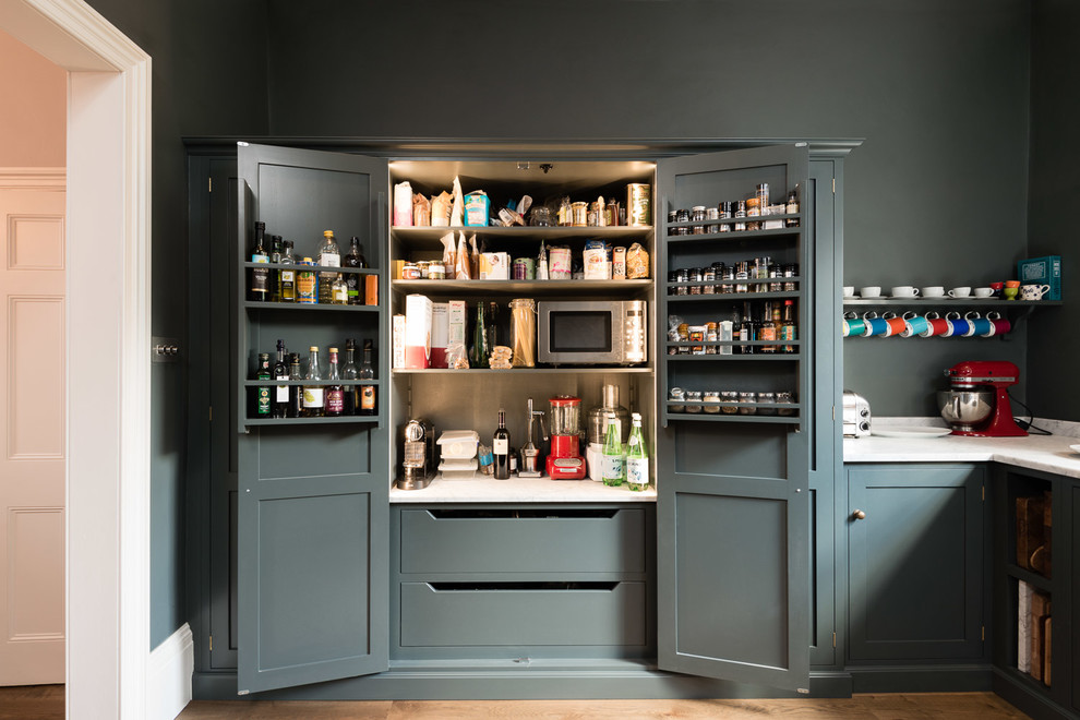 Classic kitchen pantry in London with shaker cabinets and grey cabinets.