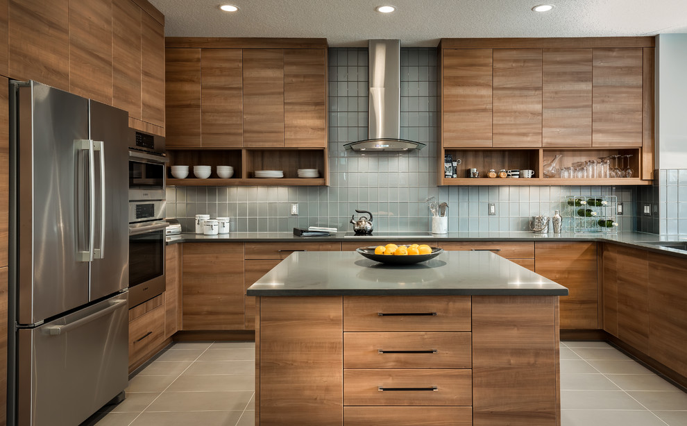 Kitchen - contemporary u-shaped kitchen idea in Calgary with an island, flat-panel cabinets, medium tone wood cabinets, gray backsplash, glass tile backsplash and stainless steel appliances