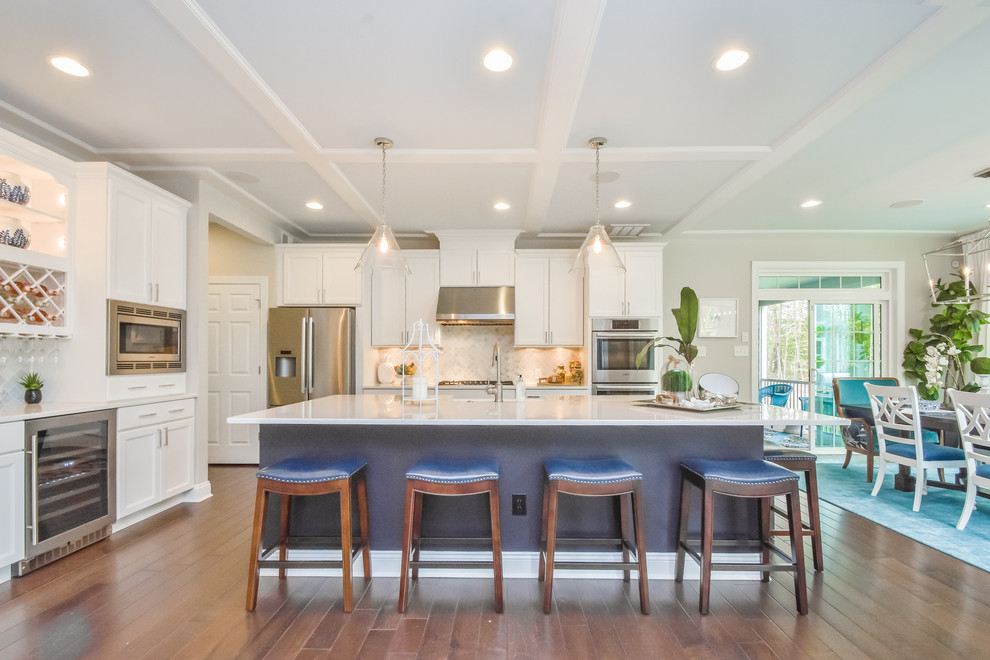 Eat-in kitchen - traditional dark wood floor eat-in kitchen idea in Other with shaker cabinets, white cabinets, multicolored backsplash, stainless steel appliances and an island
