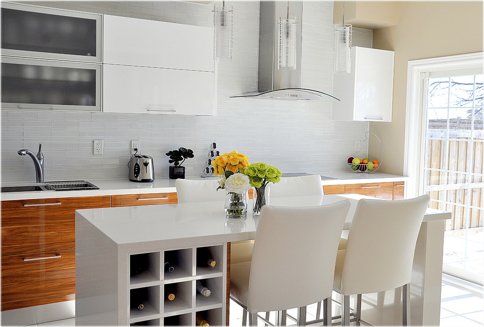 Photo of a contemporary kitchen in Toronto with flat-panel cabinets, medium wood cabinets, white splashback and matchstick tiled splashback.
