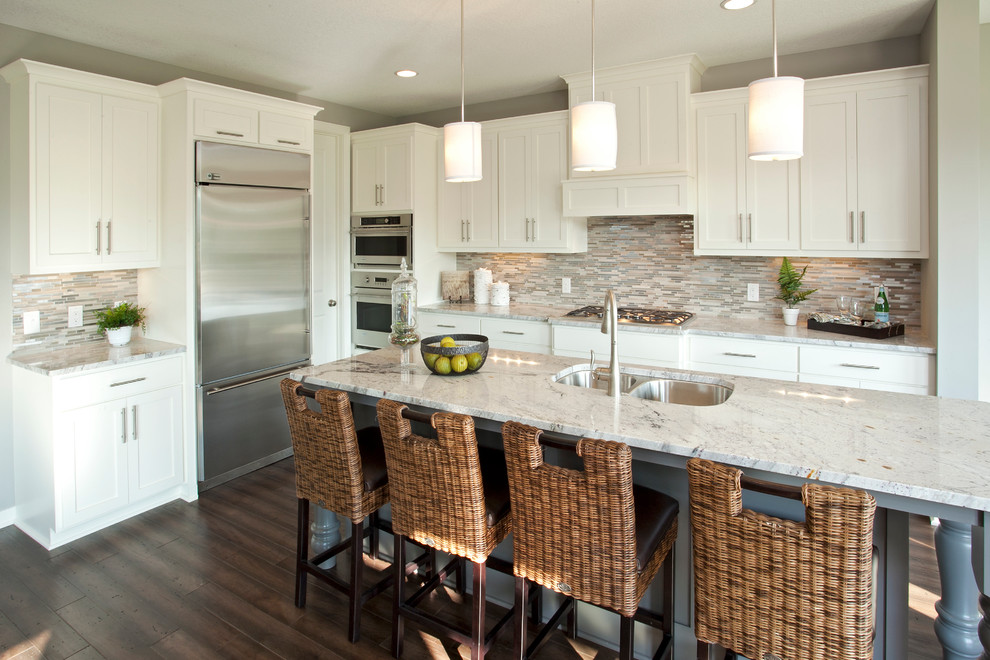 Inspiration for a transitional kitchen remodel in Minneapolis with a double-bowl sink, shaker cabinets, white cabinets, granite countertops, multicolored backsplash, matchstick tile backsplash and stainless steel appliances