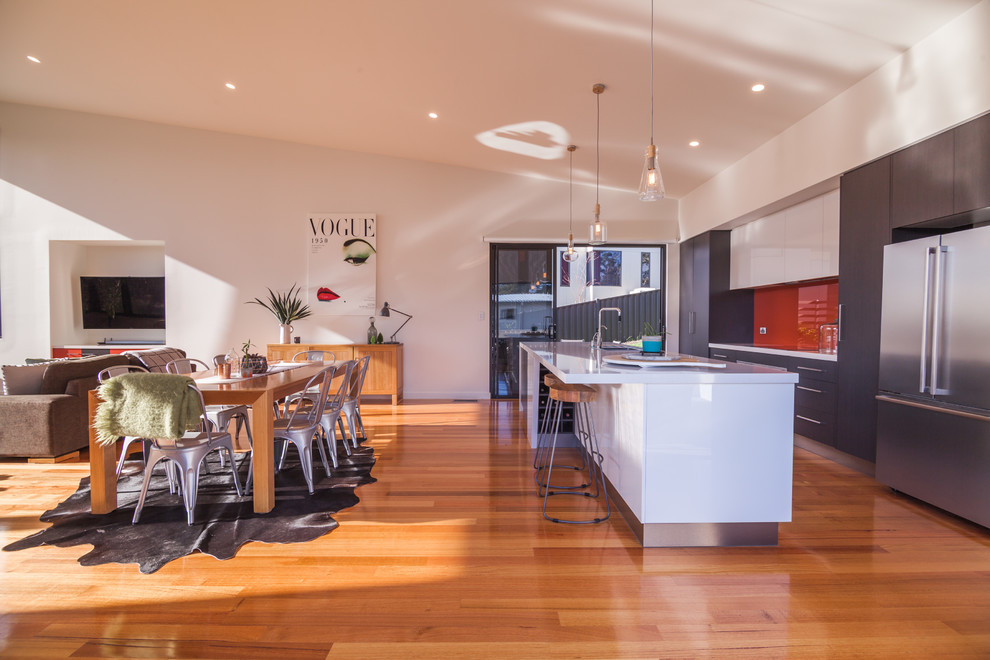 Medium sized contemporary galley kitchen/diner in Hobart with a single-bowl sink, flat-panel cabinets, grey cabinets, granite worktops, stainless steel appliances, medium hardwood flooring and an island.