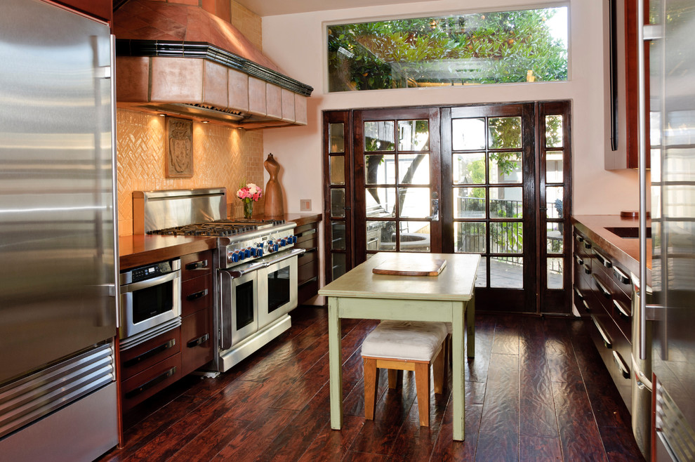 Example of a tuscan kitchen design in Los Angeles with dark wood cabinets