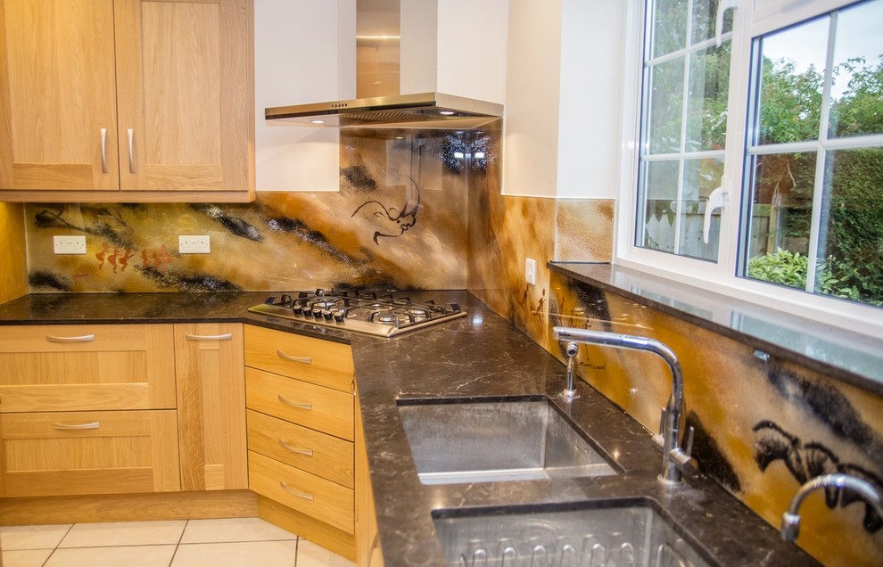 Inspiration for a tropical kitchen remodel in Hertfordshire with glass sheet backsplash