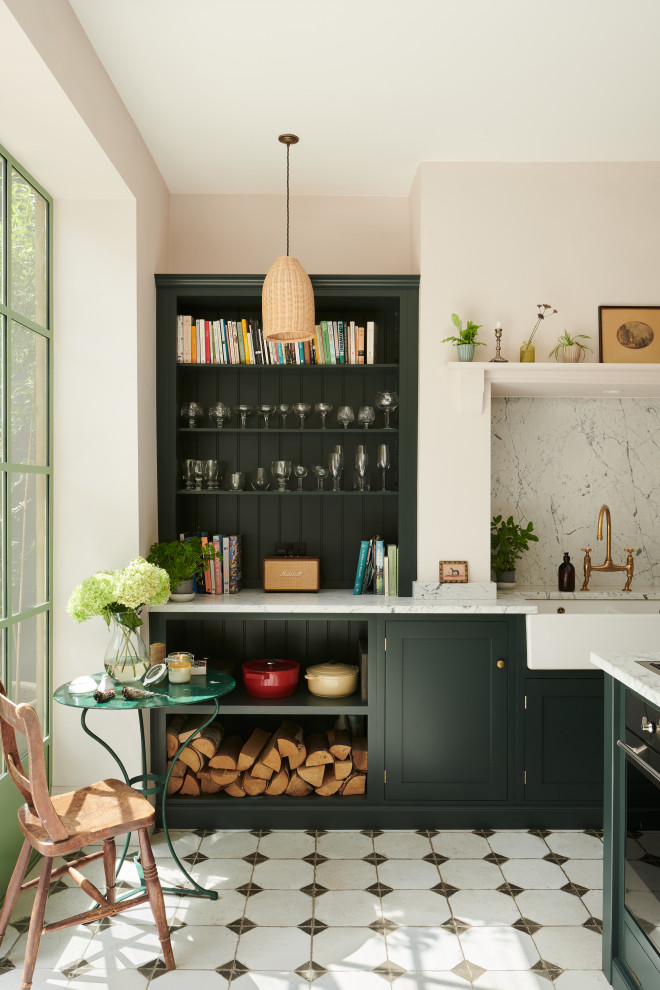 Photo of a mid-sized mediterranean separate kitchen in Other with a farmhouse sink, shaker cabinets, green cabinets, marble benchtops, white splashback, marble splashback, stainless steel appliances, ceramic floors, with island, yellow floor and white benchtop.