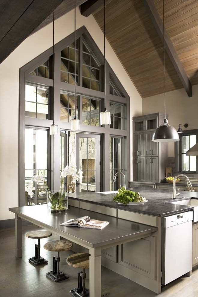Design ideas for an expansive rustic kitchen/diner in Other with a belfast sink, stainless steel appliances, light hardwood flooring and an island.