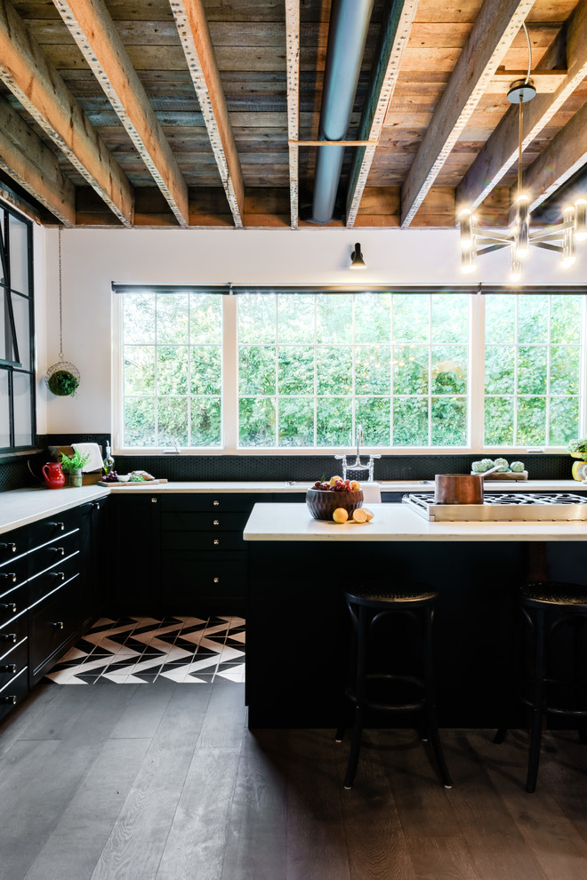 Huge urban ceramic tile and multicolored floor eat-in kitchen photo in Providence with an undermount sink, flat-panel cabinets, black cabinets, quartz countertops, black backsplash, ceramic backsplash, stainless steel appliances, an island and white countertops