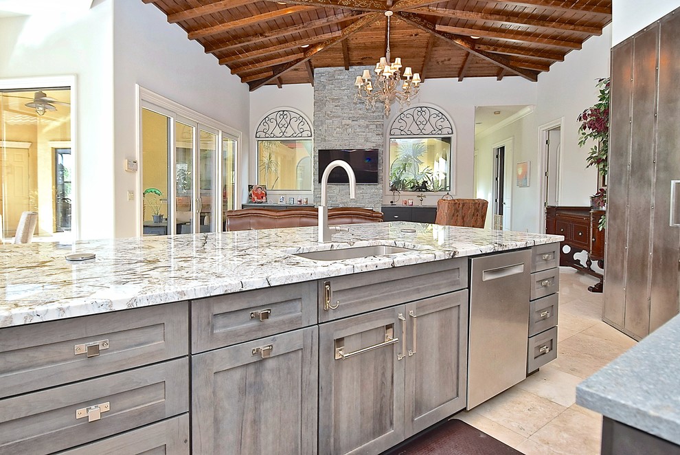 Example of a large trendy u-shaped beige floor and ceramic tile open concept kitchen design in Tampa with an undermount sink, recessed-panel cabinets, medium tone wood cabinets, granite countertops, multicolored backsplash, mosaic tile backsplash, stainless steel appliances, two islands and white countertops