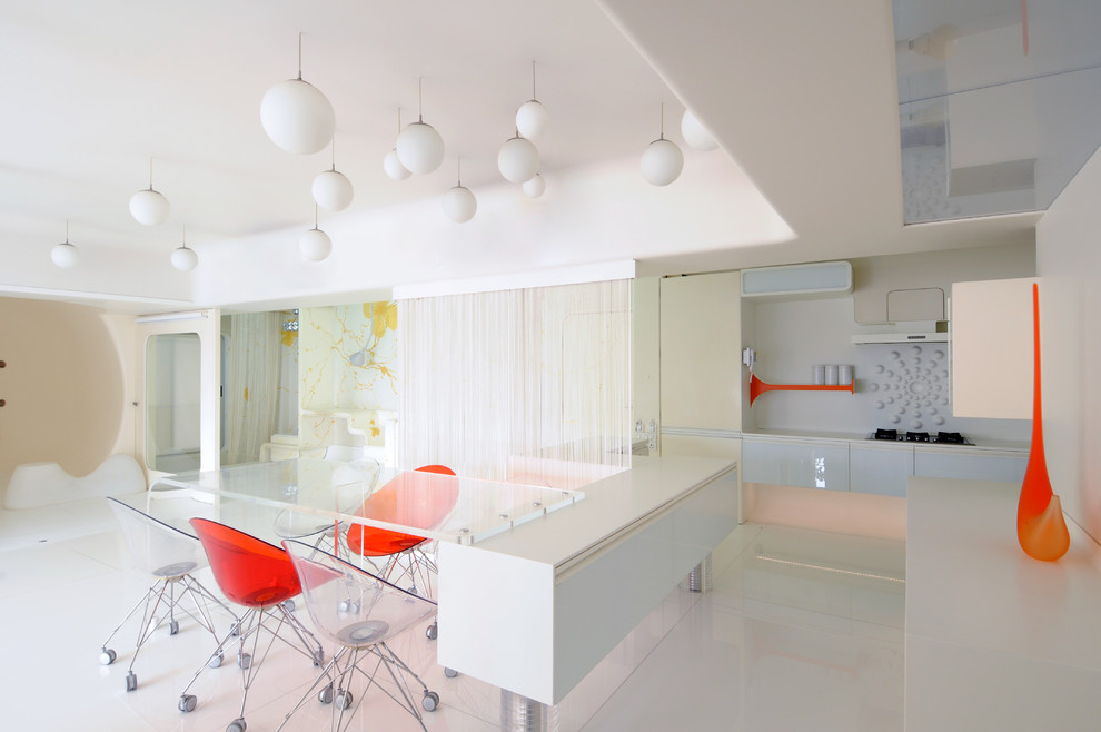 This is an example of a contemporary l-shaped open plan kitchen in Pune with white cabinets, white splashback and an island.