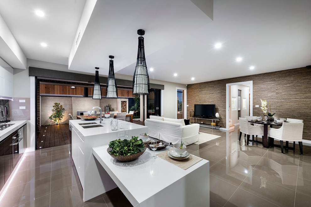 This is an example of a modern kitchen/diner in Canberra - Queanbeyan with a double-bowl sink, engineered stone countertops, stainless steel appliances and an island.