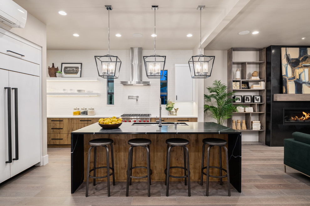 Inspiration for a contemporary l-shaped dark wood floor and brown floor kitchen remodel in Seattle with an undermount sink, flat-panel cabinets, medium tone wood cabinets, white backsplash, stainless steel appliances, an island and white countertops