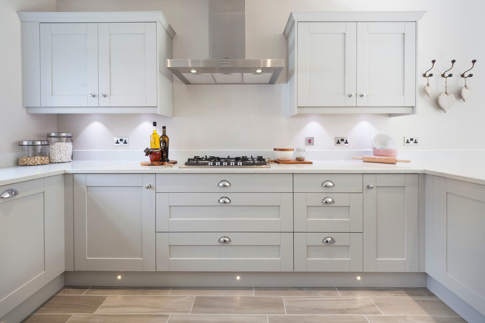 Classic u-shaped kitchen in Dorset with recessed-panel cabinets and grey cabinets.