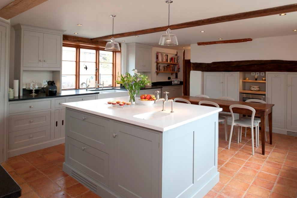 Example of a mountain style kitchen design in Kent with shaker cabinets and a farmhouse sink
