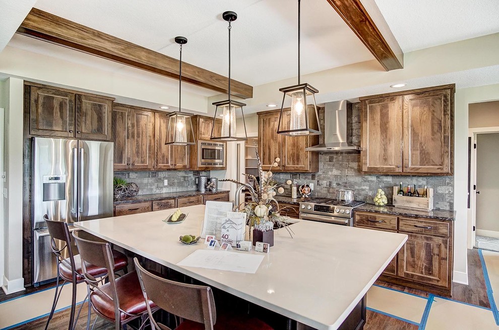 Large mountain style l-shaped dark wood floor and brown floor open concept kitchen photo in Other with a single-bowl sink, shaker cabinets, distressed cabinets, quartzite countertops, multicolored backsplash, brick backsplash, stainless steel appliances, an island and white countertops