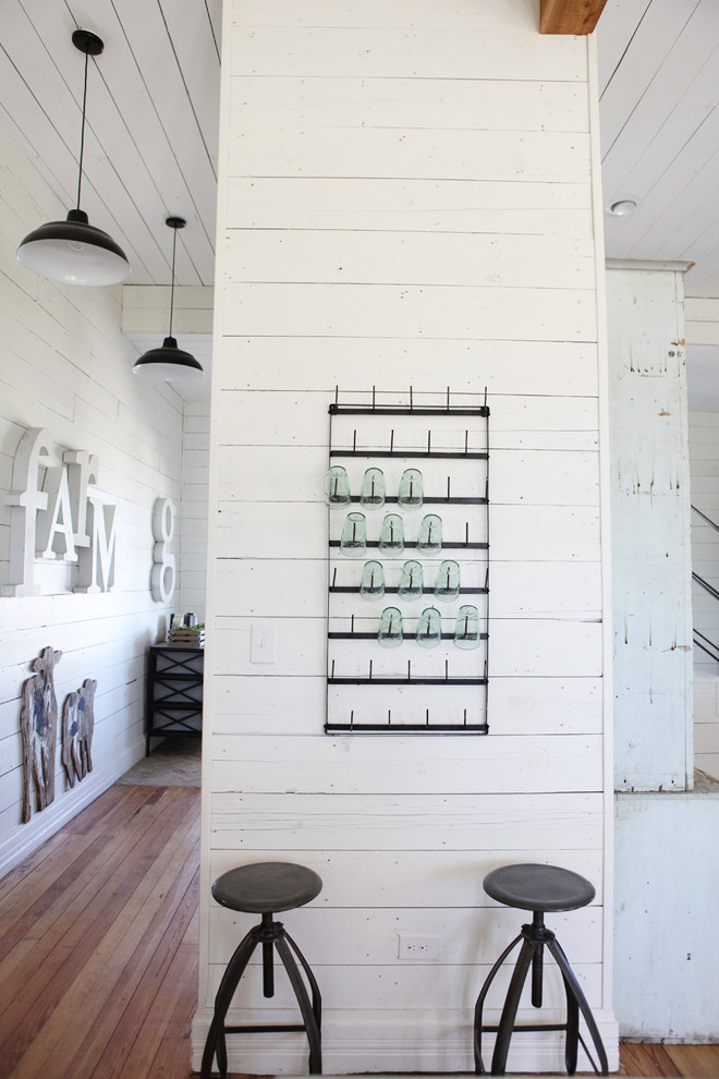 Example of a mid-sized farmhouse medium tone wood floor kitchen design in Austin with a farmhouse sink, concrete countertops, white backsplash, subway tile backsplash, stainless steel appliances and an island