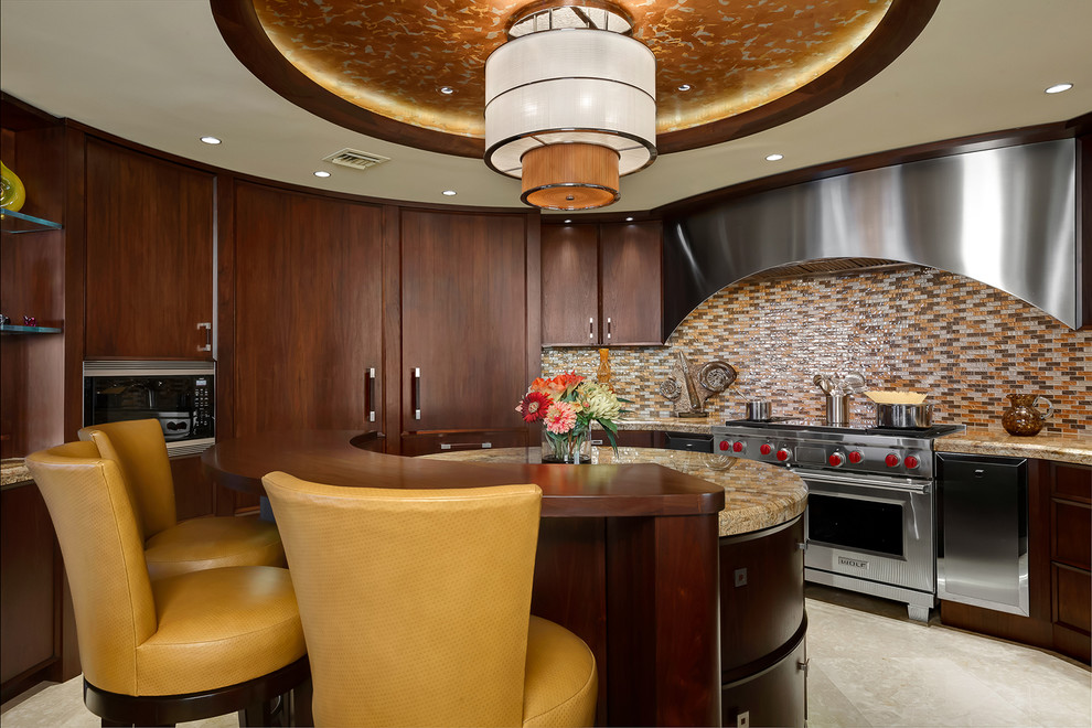 Contemporary kitchen in Tampa with flat-panel cabinets, dark wood cabinets, multi-coloured splashback, mosaic tiled splashback, stainless steel appliances and an island.