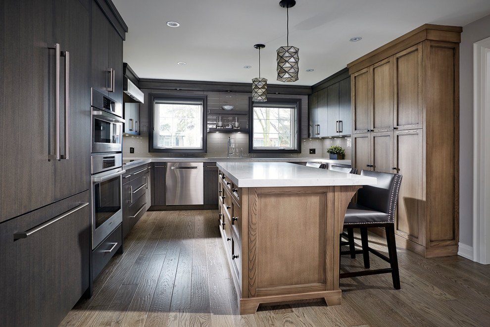 Large transitional u-shaped light wood floor eat-in kitchen photo in Toronto with recessed-panel cabinets, medium tone wood cabinets, quartzite countertops, gray backsplash, glass tile backsplash, stainless steel appliances, an island, white countertops and an undermount sink
