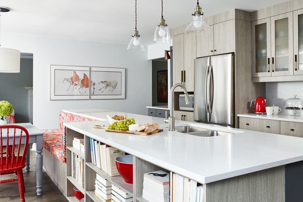 Photo of a large traditional l-shaped kitchen/diner in Toronto with stainless steel appliances, an island, a double-bowl sink, shaker cabinets, engineered stone countertops, multi-coloured splashback, porcelain splashback, medium hardwood flooring and light wood cabinets.