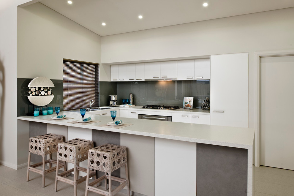 Photo of a medium sized modern u-shaped kitchen in Perth with flat-panel cabinets, white cabinets, grey splashback, glass sheet splashback, a double-bowl sink, stainless steel appliances and an island.