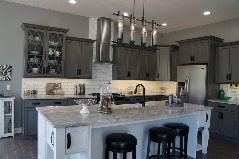 Eat-in kitchen - industrial eat-in kitchen idea in Cleveland with a farmhouse sink, gray cabinets, quartz countertops, white backsplash, mosaic tile backsplash and stainless steel appliances