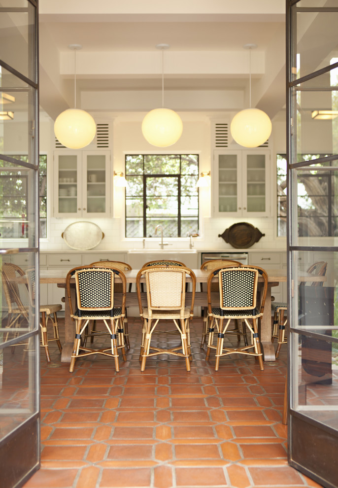Example of a mountain style kitchen design in Los Angeles with glass-front cabinets