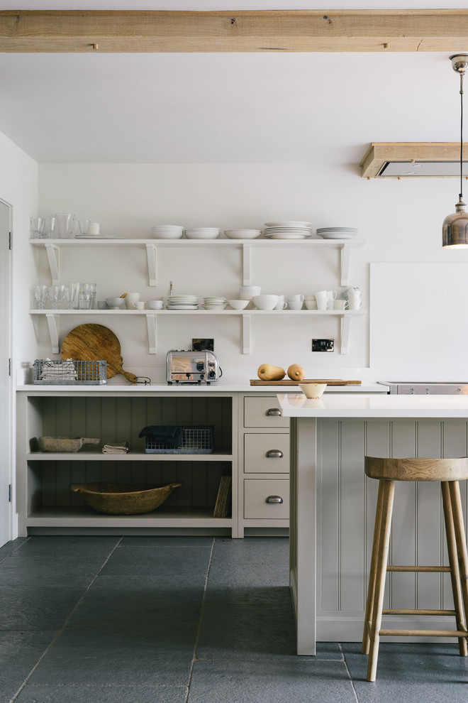 Photo of a large farmhouse single-wall open plan kitchen in Other with a belfast sink, shaker cabinets, grey cabinets, quartz worktops, white splashback and an island.