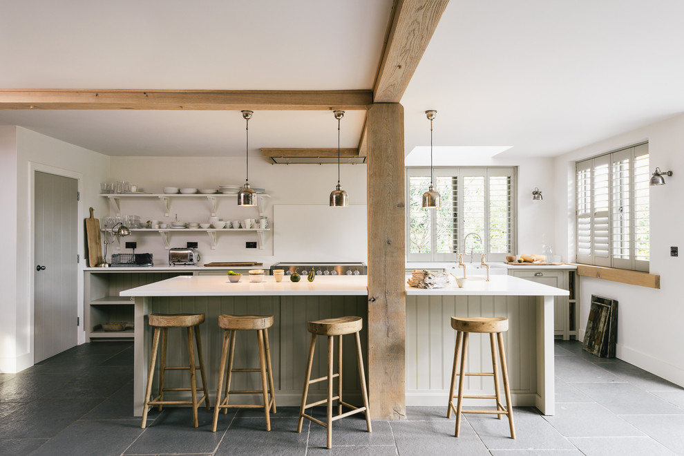 Photo of a large rural single-wall kitchen in Other with a belfast sink, shaker cabinets, grey cabinets, quartz worktops, white splashback and an island.