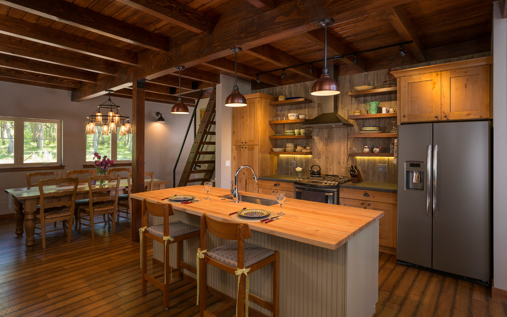 Inspiration for a mid-sized rustic dark wood floor eat-in kitchen remodel in Albuquerque with ceramic backsplash, an island, an undermount sink, shaker cabinets, medium tone wood cabinets, wood countertops and gray backsplash