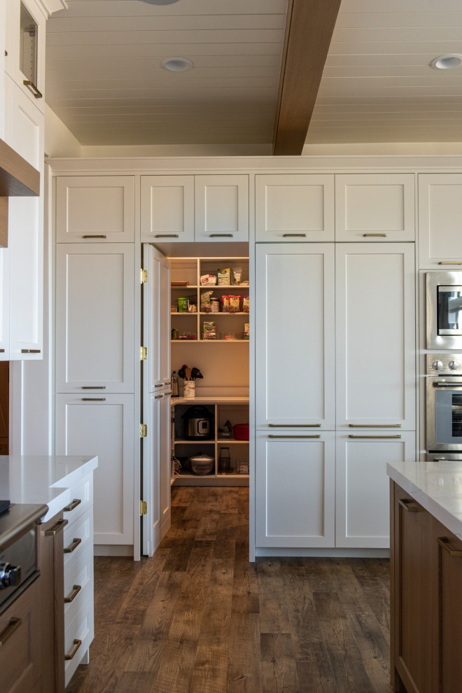 Inspiration for a large farmhouse eat-in kitchen remodel in Salt Lake City with white cabinets and an island