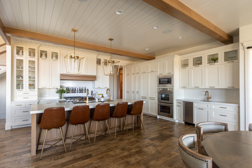Photo of a large farmhouse kitchen/diner in Salt Lake City with white cabinets and an island.