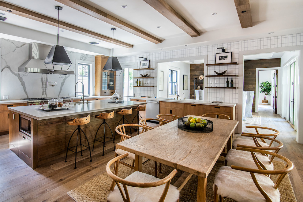 Eat-in kitchen - large country l-shaped medium tone wood floor and brown floor eat-in kitchen idea in Los Angeles with an undermount sink, flat-panel cabinets, medium tone wood cabinets, white backsplash, stainless steel appliances, an island and gray countertops