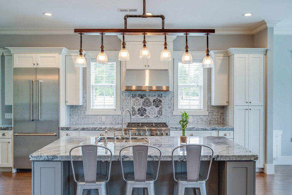 Cottage galley medium tone wood floor and brown floor open concept kitchen photo in Other with a double-bowl sink, shaker cabinets, white cabinets, granite countertops, gray backsplash, stone tile backsplash, stainless steel appliances and an island