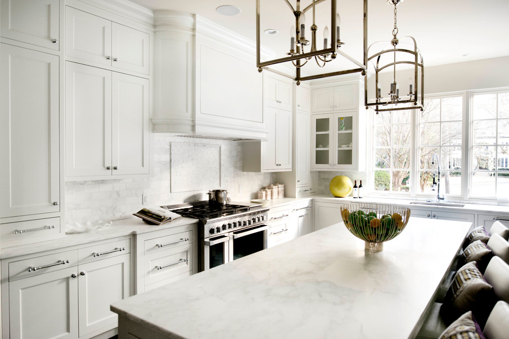 Kitchen - transitional kitchen idea in Atlanta with white cabinets and marble countertops