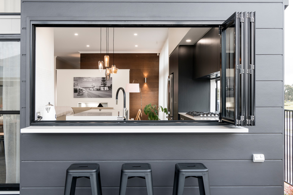 Moderne Küche in L-Form mit flächenbündigen Schrankfronten, schwarzen Schränken, Küchengeräten aus Edelstahl und Kücheninsel in Perth