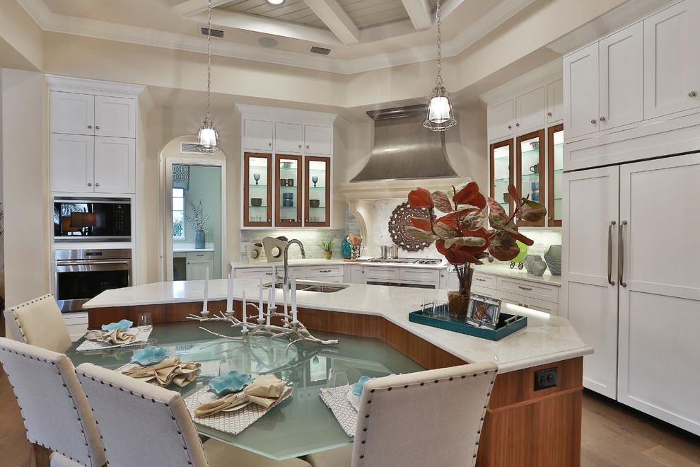 Design ideas for a contemporary u-shaped kitchen/diner in Tampa with a submerged sink, flat-panel cabinets, white cabinets, composite countertops, multi-coloured splashback, mosaic tiled splashback, integrated appliances, medium hardwood flooring and an island.