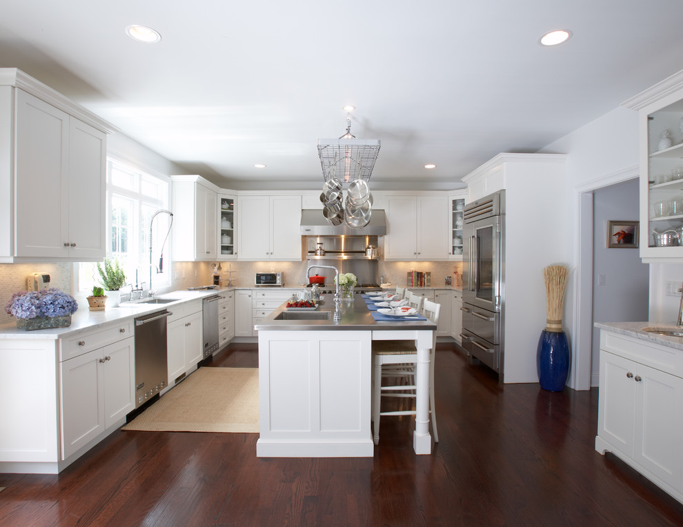 Inspiration for a large transitional u-shaped dark wood floor eat-in kitchen remodel in Other with shaker cabinets, white cabinets, stainless steel countertops, white backsplash, stainless steel appliances and an island