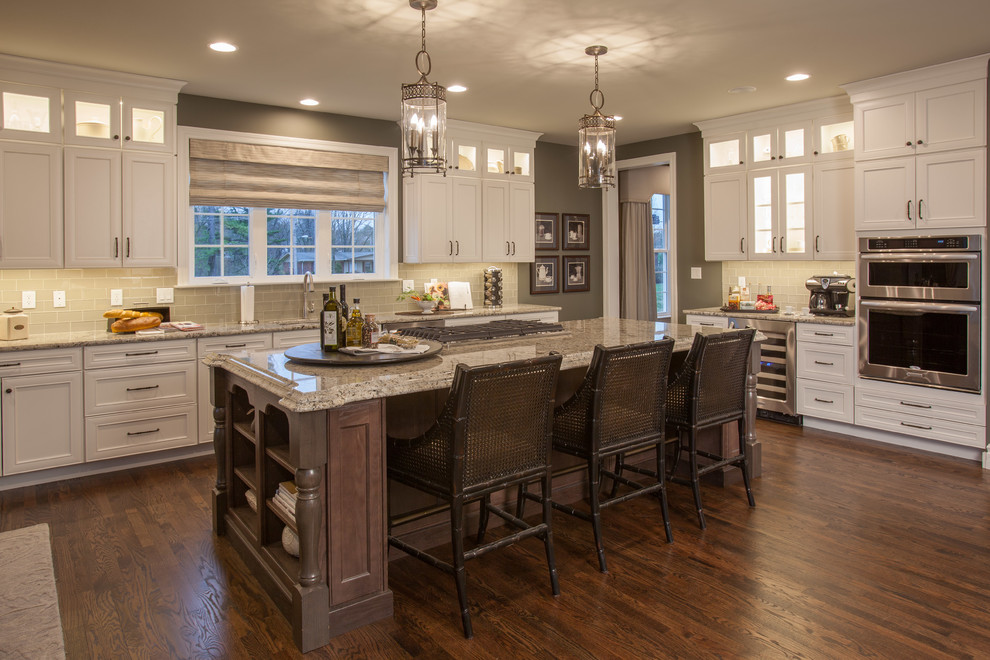 Huge trendy medium tone wood floor kitchen photo in St Louis with a double-bowl sink, raised-panel cabinets, light wood cabinets, granite countertops, beige backsplash, cement tile backsplash, stainless steel appliances and an island