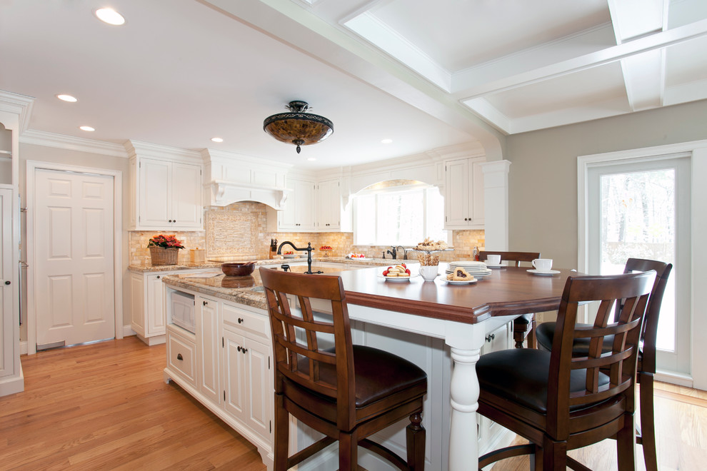 Inspiration for a classic l-shaped open plan kitchen in Bridgeport with raised-panel cabinets, white cabinets and integrated appliances.