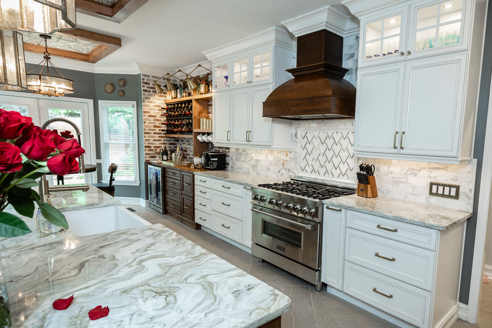 Inspiration for a large timeless l-shaped porcelain tile and beige floor open concept kitchen remodel in Atlanta with a farmhouse sink, flat-panel cabinets, white cabinets, marble countertops, multicolored backsplash, marble backsplash, stainless steel appliances, an island and white countertops