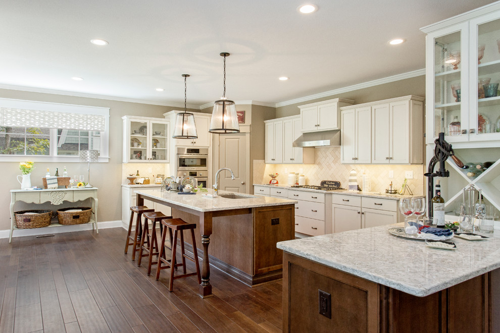 Inspiration for a mid-sized craftsman l-shaped dark wood floor open concept kitchen remodel in Richmond with white cabinets, granite countertops, beige backsplash, stainless steel appliances, an island, recessed-panel cabinets, a double-bowl sink and subway tile backsplash