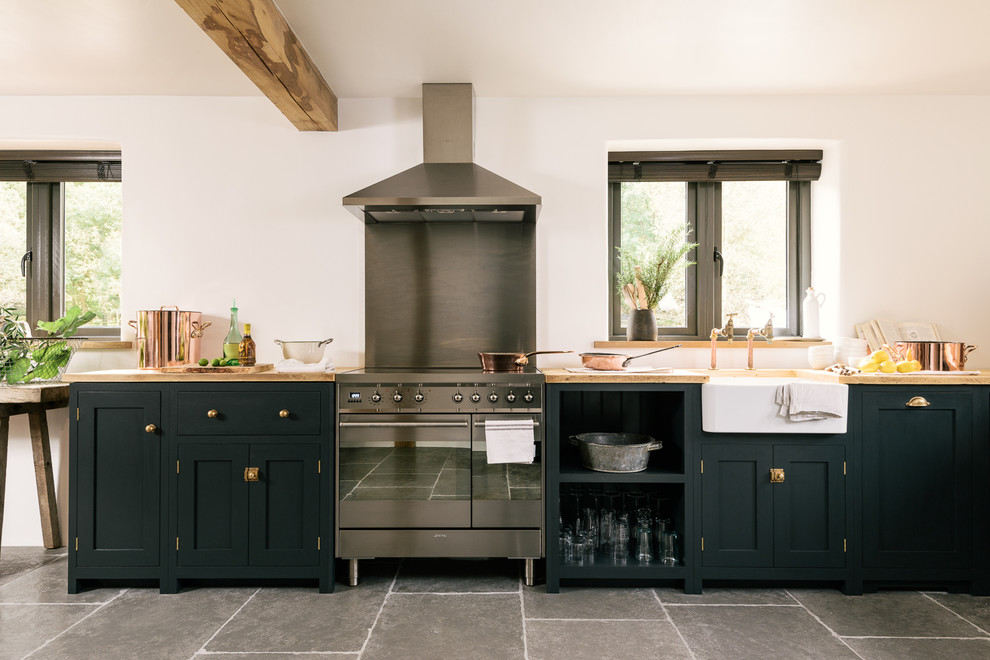 Design ideas for a large rustic l-shaped kitchen/diner in Other with open cabinets, blue cabinets, wood worktops, limestone flooring and no island.